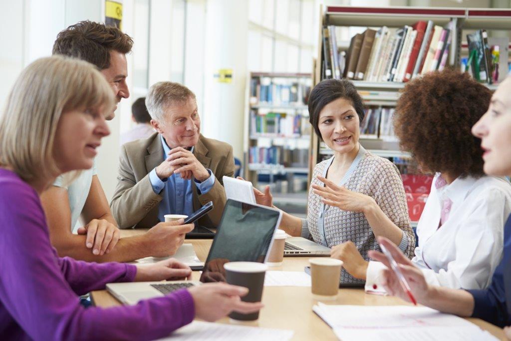 Adult educators collaborating around a table