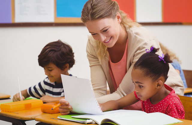 Teacher helping students in classroom