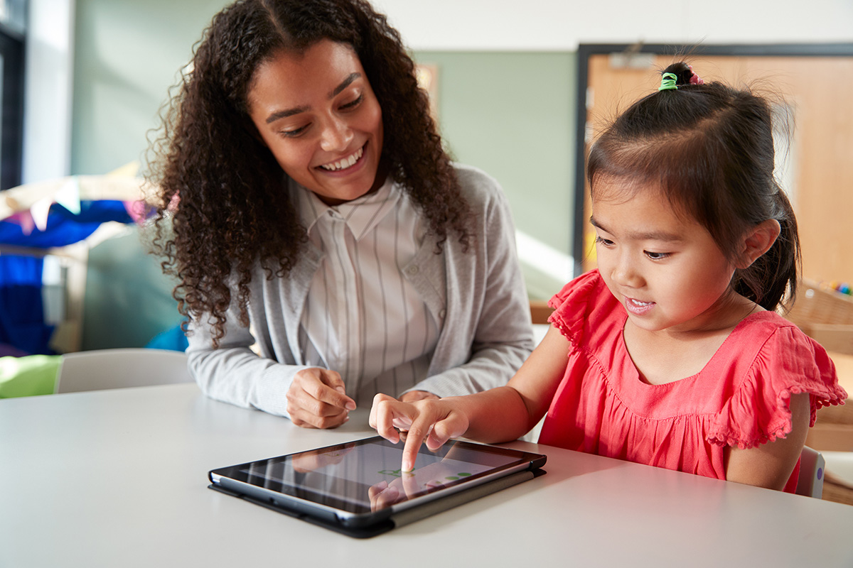 Student and teacher working with tablet