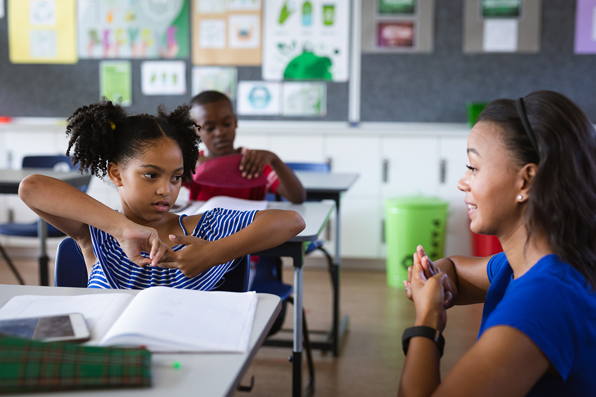 Teacher and student practicing sign language