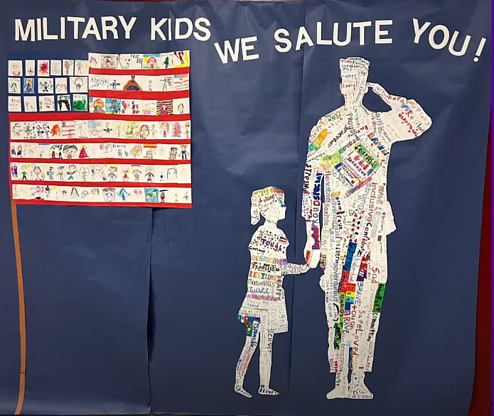 Collage of children's artwork combined to represent the US flag and a soldier holding the hand of a child.