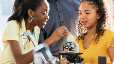 students using a microscope